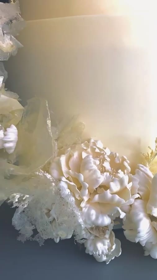 Deep, velvety chocolate draped in delicate ivory lace and crowned with hand-sculpted chocolate peonies, rich meets refined, for a wedding cake that feels nothing short of magical