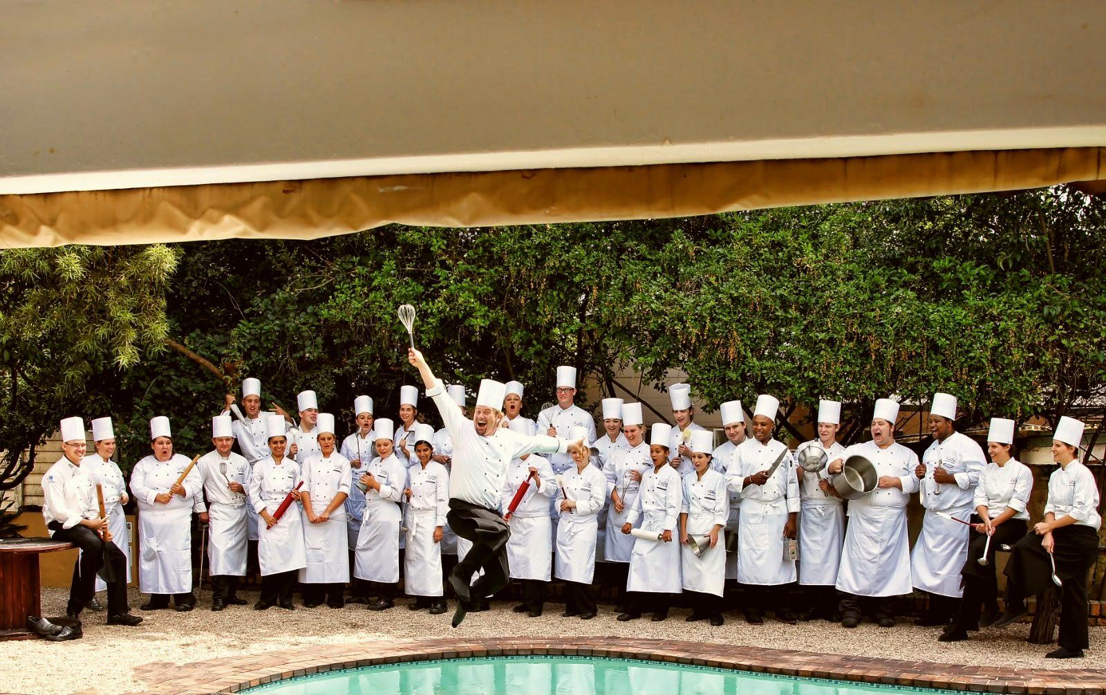 A kitchen full of chefs, and the man who taught them